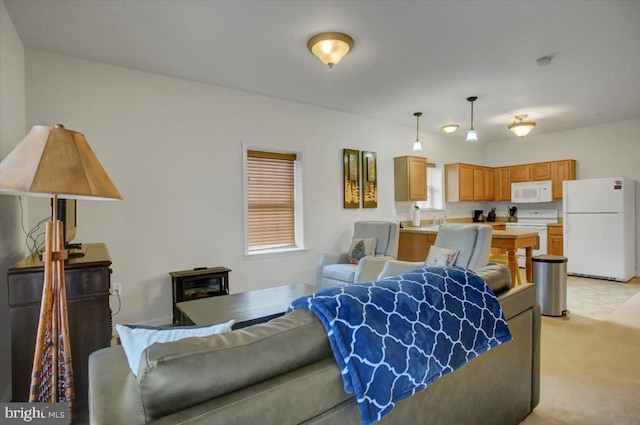 living room featuring light carpet and plenty of natural light