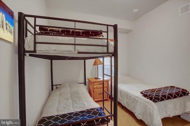 bedroom with carpet floors and visible vents