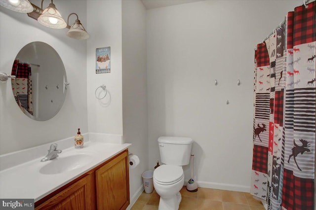 full bathroom featuring toilet, tile patterned floors, baseboards, and vanity