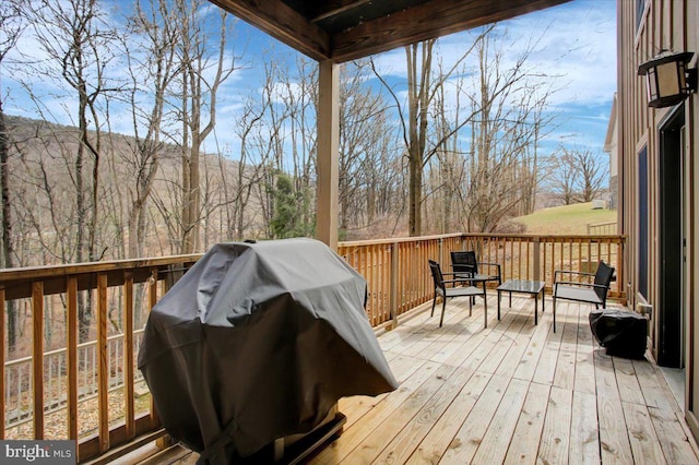 wooden terrace featuring grilling area