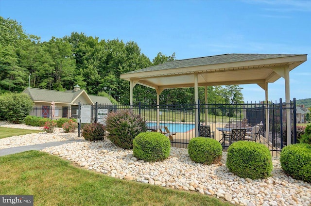 surrounding community with fence and a pool