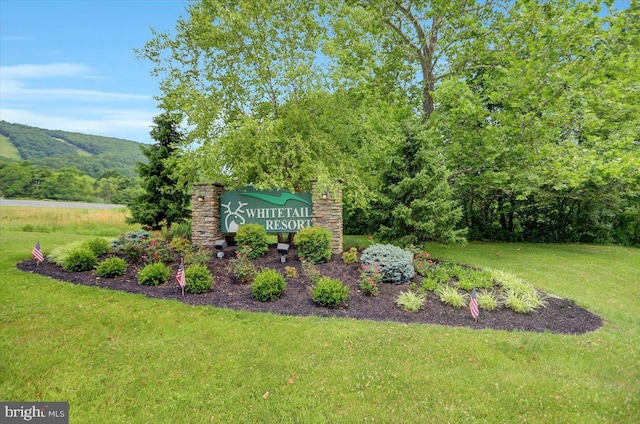 community / neighborhood sign with a lawn