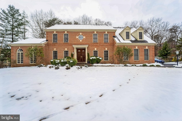 colonial-style house with brick siding