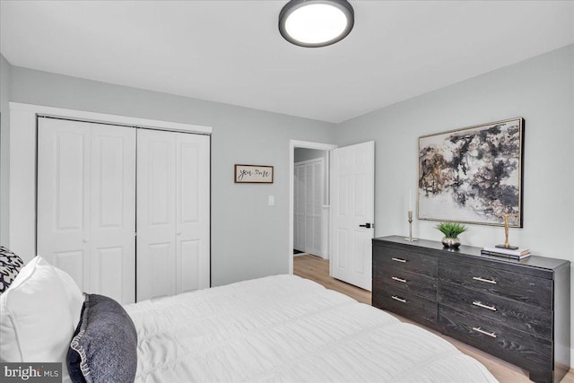 bedroom with a closet and wood finished floors