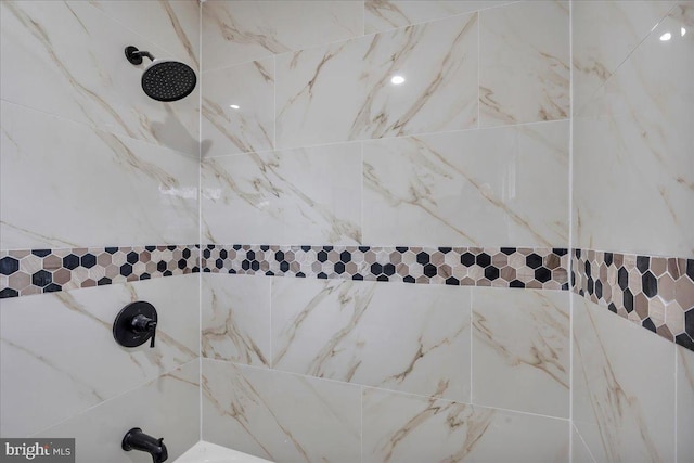 interior details featuring a tile shower