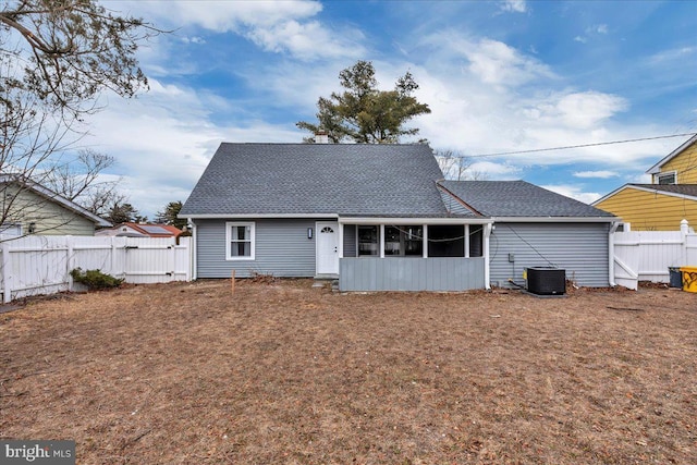 back of property featuring a sunroom, fence, cooling unit, and roof with shingles