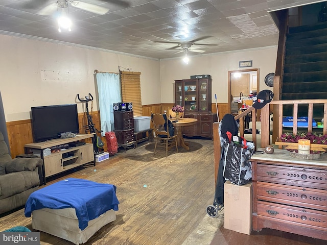 office with ceiling fan, wooden walls, wood finished floors, and wainscoting