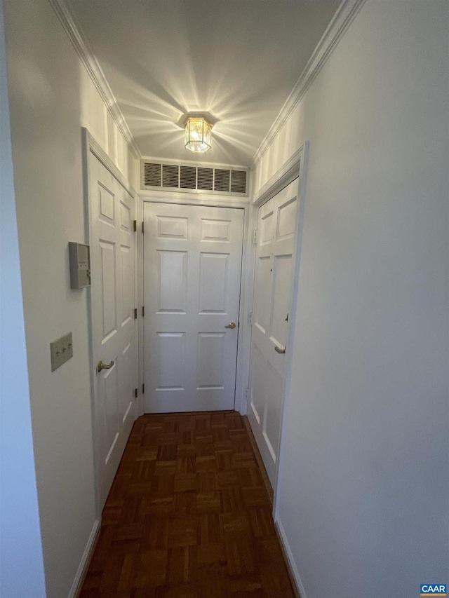 doorway with visible vents and crown molding