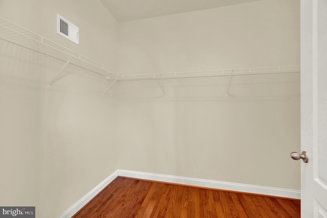 walk in closet with visible vents and wood finished floors