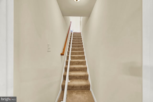 stairway with carpet flooring, visible vents, and baseboards