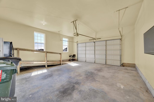 garage with baseboards and a garage door opener