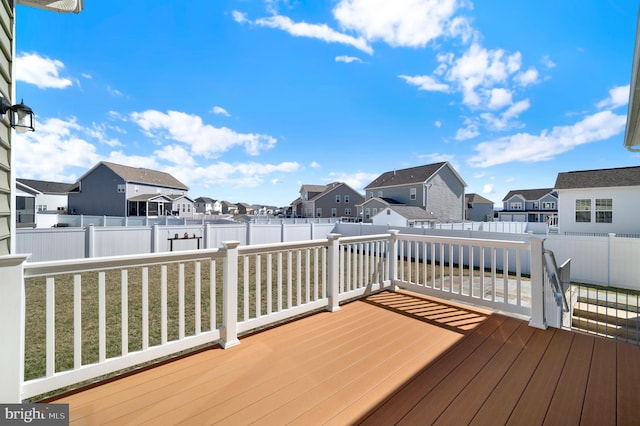 wooden deck with a residential view and a fenced backyard