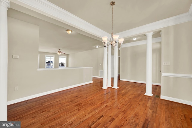 unfurnished dining area with decorative columns, baseboards, ceiling fan, ornamental molding, and wood finished floors