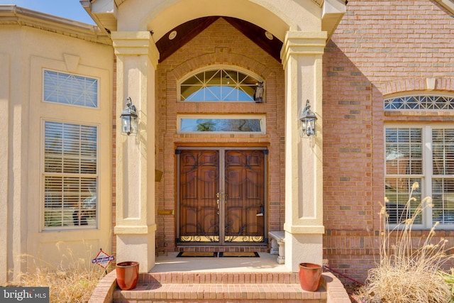 property entrance with brick siding