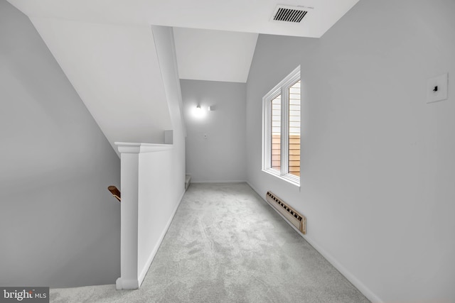 bonus room with a baseboard radiator, lofted ceiling, visible vents, carpet flooring, and baseboards