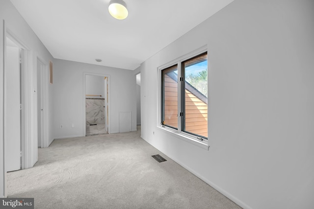 unfurnished bedroom featuring carpet and visible vents