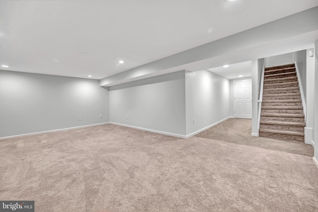 finished below grade area featuring baseboards, stairway, carpet flooring, and recessed lighting