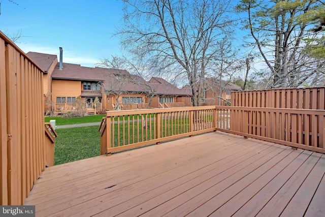 wooden deck with a lawn and a residential view