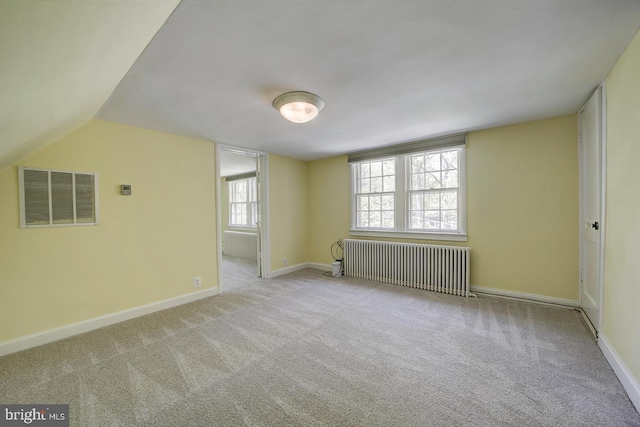 interior space featuring carpet flooring, baseboards, visible vents, and radiator