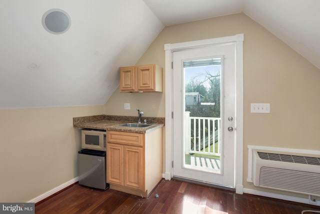 interior space with an AC wall unit, a sink, dark wood-type flooring, and lofted ceiling