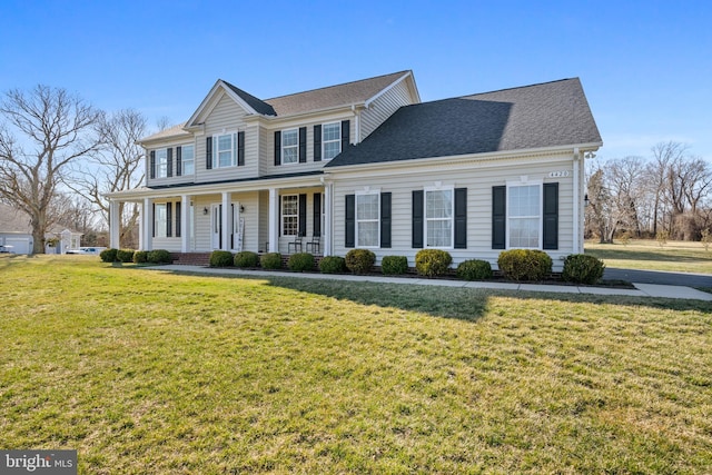 view of front of house featuring covered porch, a front lawn, and a shingled roof