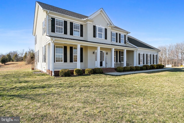 view of front facade with a front lawn and covered porch