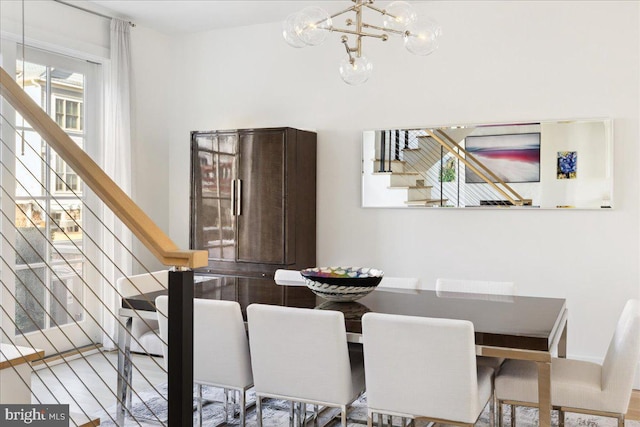 dining room with stairway and a chandelier