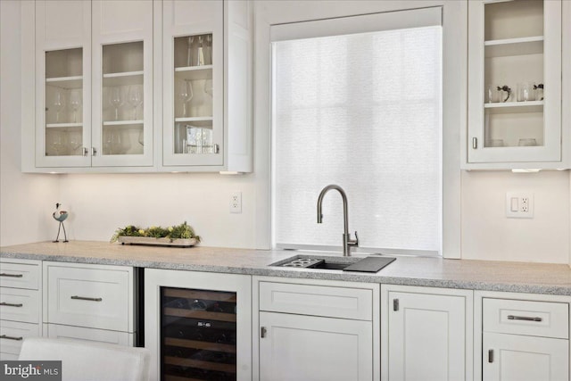 bar featuring beverage cooler and a sink