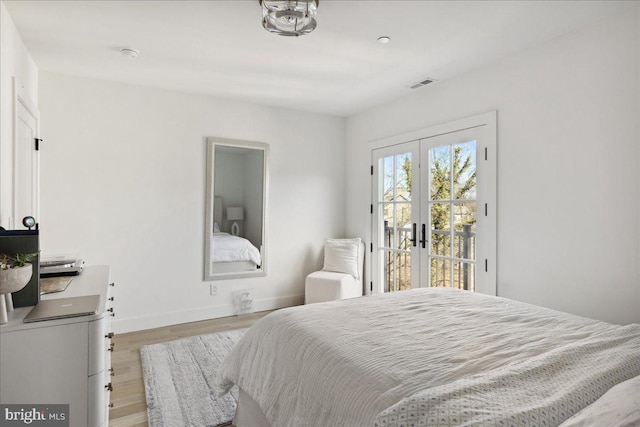 bedroom featuring visible vents, light wood-style flooring, access to outside, french doors, and baseboards