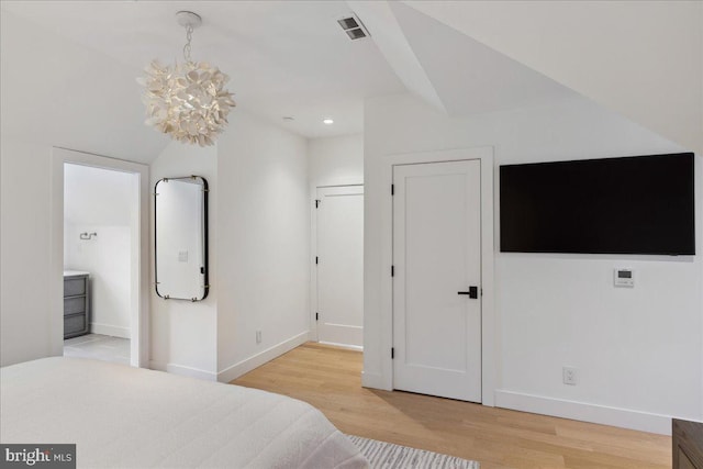 bedroom with light wood-type flooring, visible vents, and baseboards