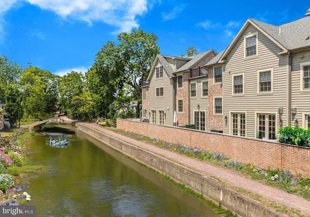 back of property with a water view