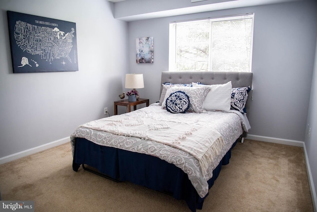 carpeted bedroom with baseboards