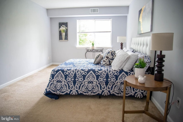 carpeted bedroom featuring visible vents and baseboards