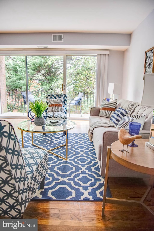 living room with visible vents and wood finished floors