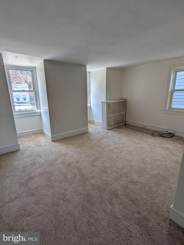 carpeted spare room with baseboards