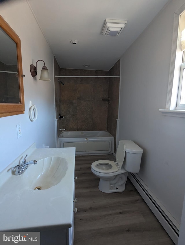 full bath with a baseboard heating unit, vanity, wood finished floors, and toilet