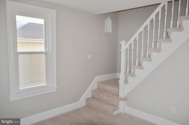 staircase with carpet flooring and baseboards