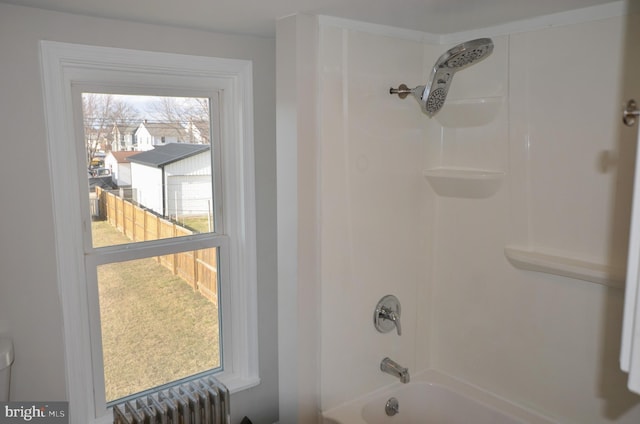 full bathroom featuring radiator and shower / bath combination