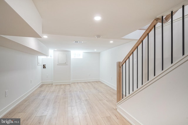 basement with recessed lighting, visible vents, stairway, light wood-style flooring, and baseboards