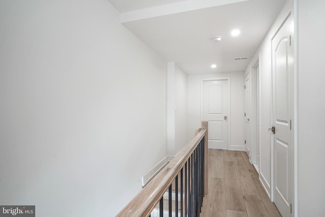 hall featuring recessed lighting, visible vents, baseboards, an upstairs landing, and light wood-style floors