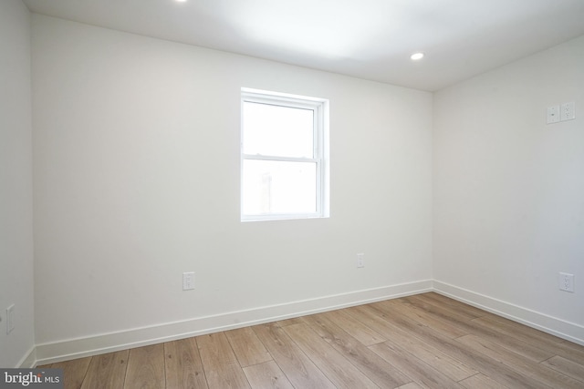 unfurnished room featuring light wood-type flooring, baseboards, and recessed lighting