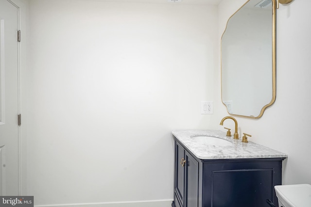 bathroom with toilet and vanity