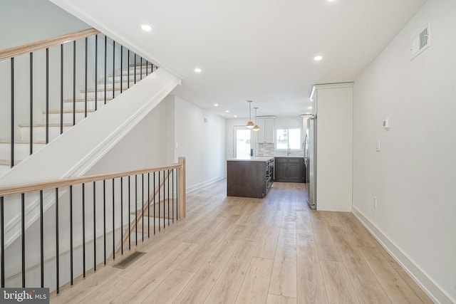 interior space with light wood-style flooring, visible vents, and recessed lighting