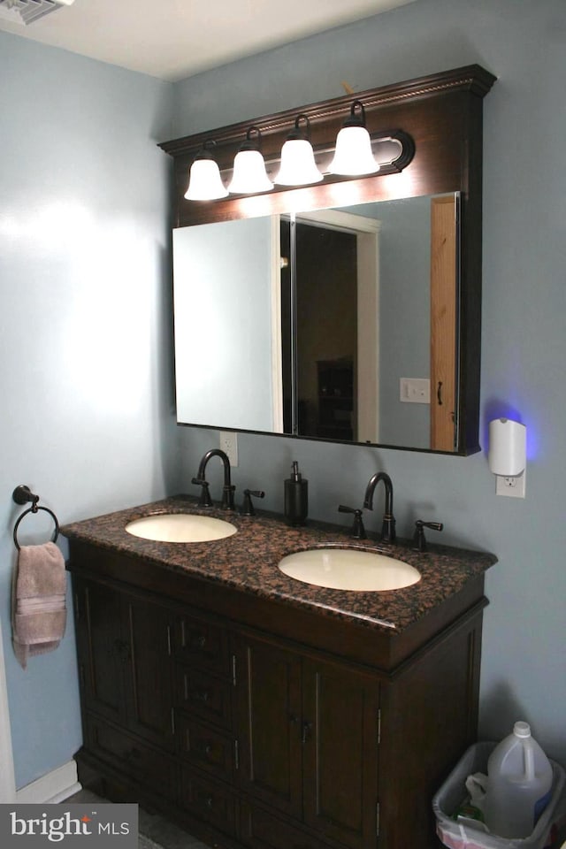 bathroom featuring double vanity and a sink