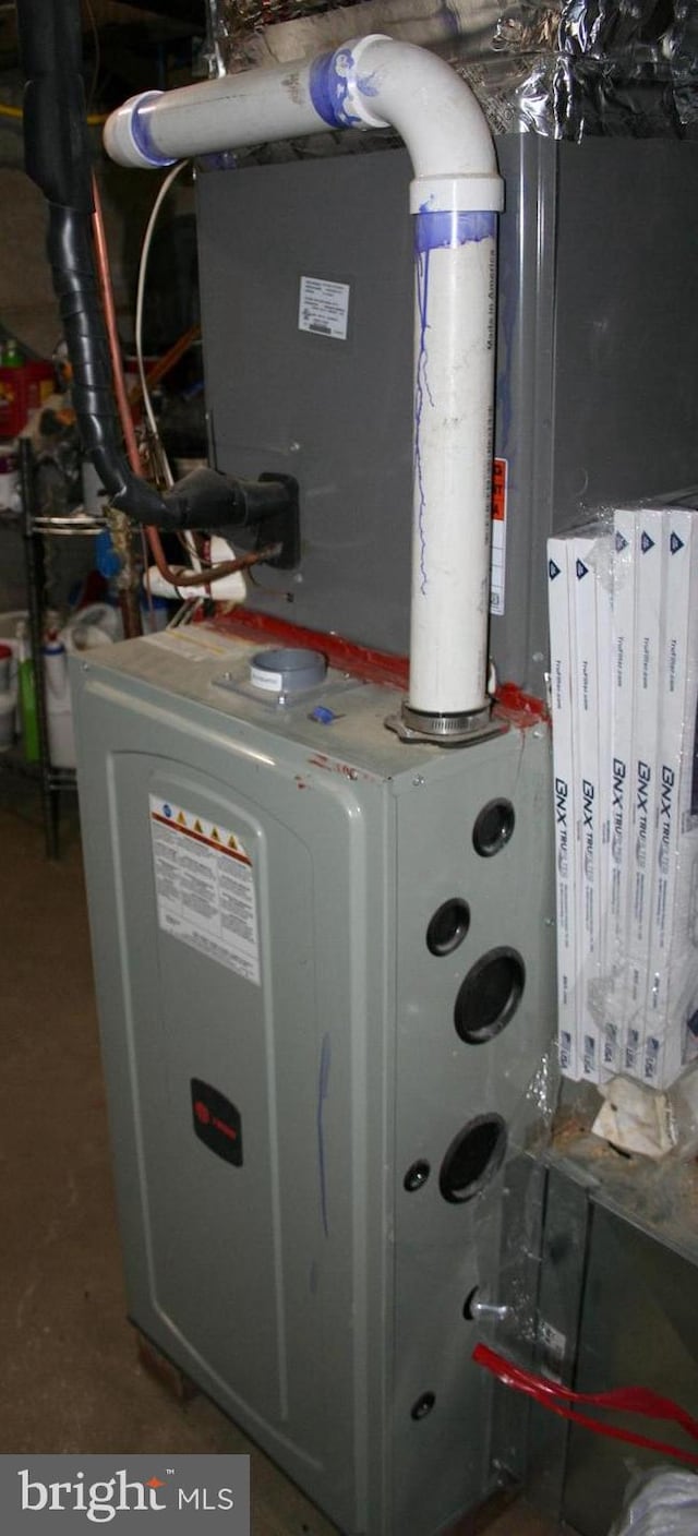 utility room featuring heating unit