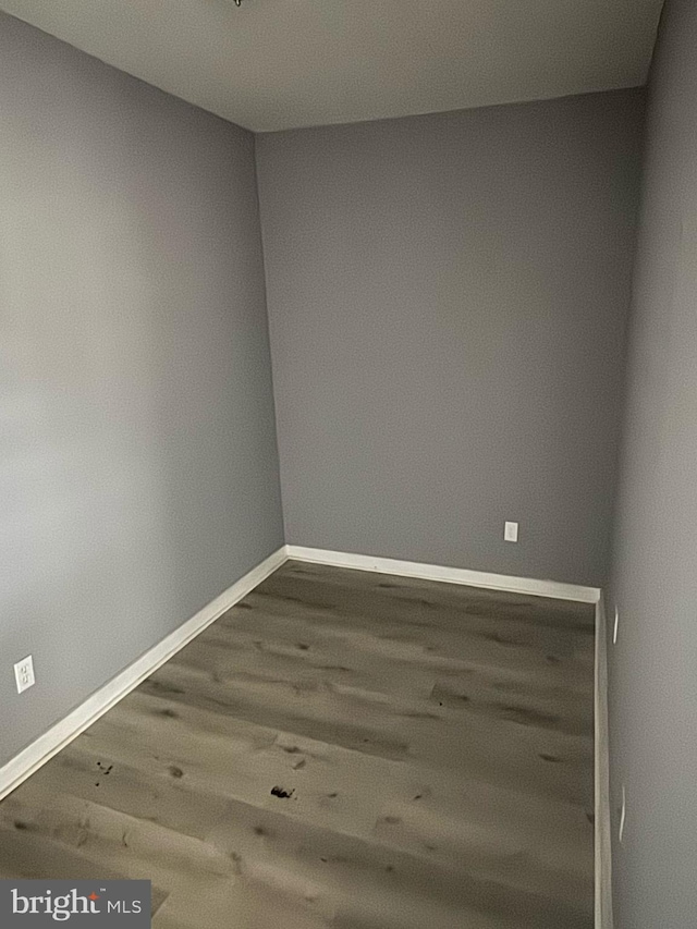 unfurnished room featuring wood finished floors and baseboards