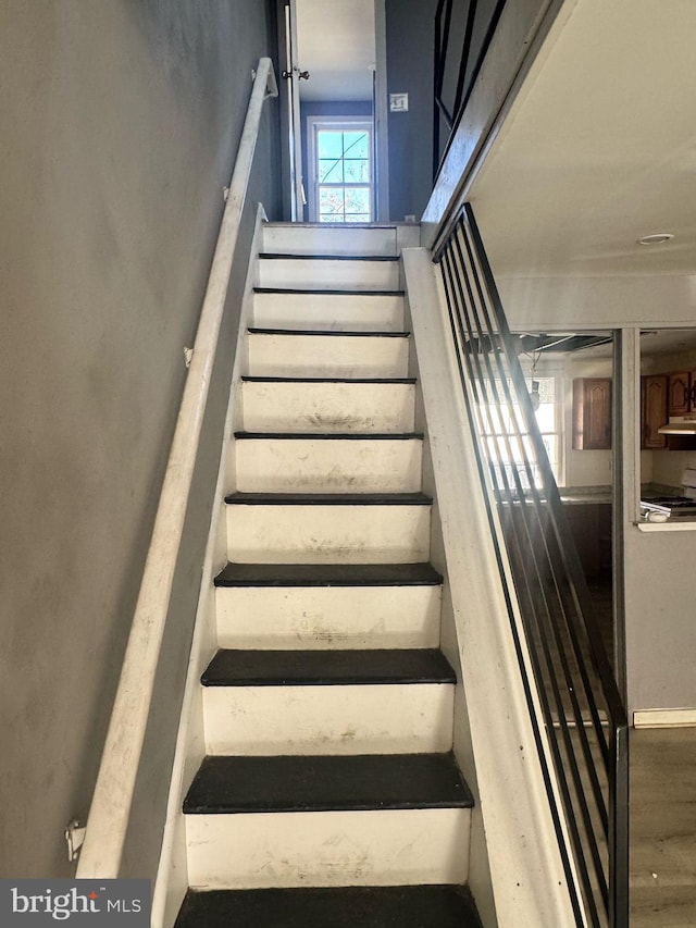 staircase with wood finished floors