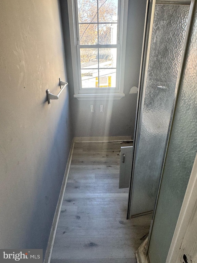 bathroom with wood finished floors and baseboards