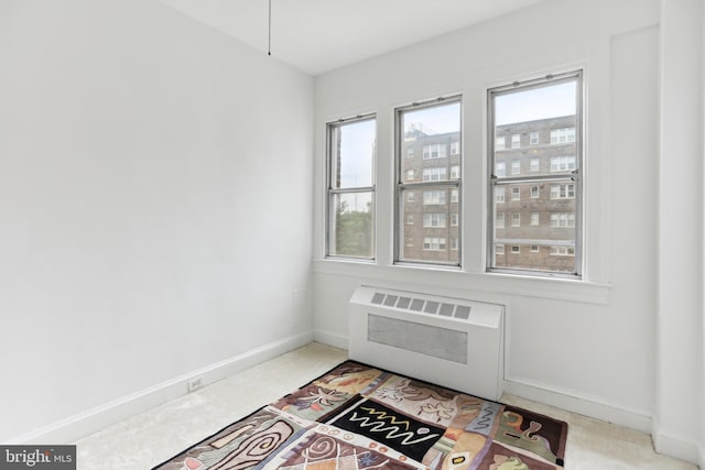 interior space featuring radiator heating unit and baseboards