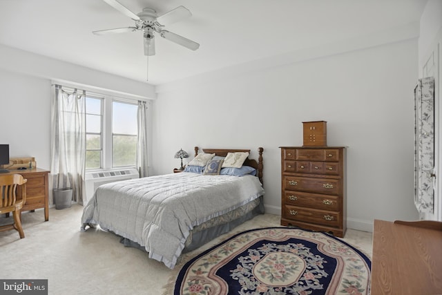 bedroom featuring ceiling fan, a wall mounted AC, baseboards, and light colored carpet